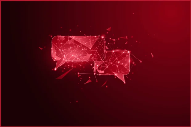 Kommunikation dargestellt durch zwei leuchtende digitale Sprechblasen aus vernetzten Polygonlinien auf dunkelrotem Hintergrund mit glühenden Partikeleffekten.